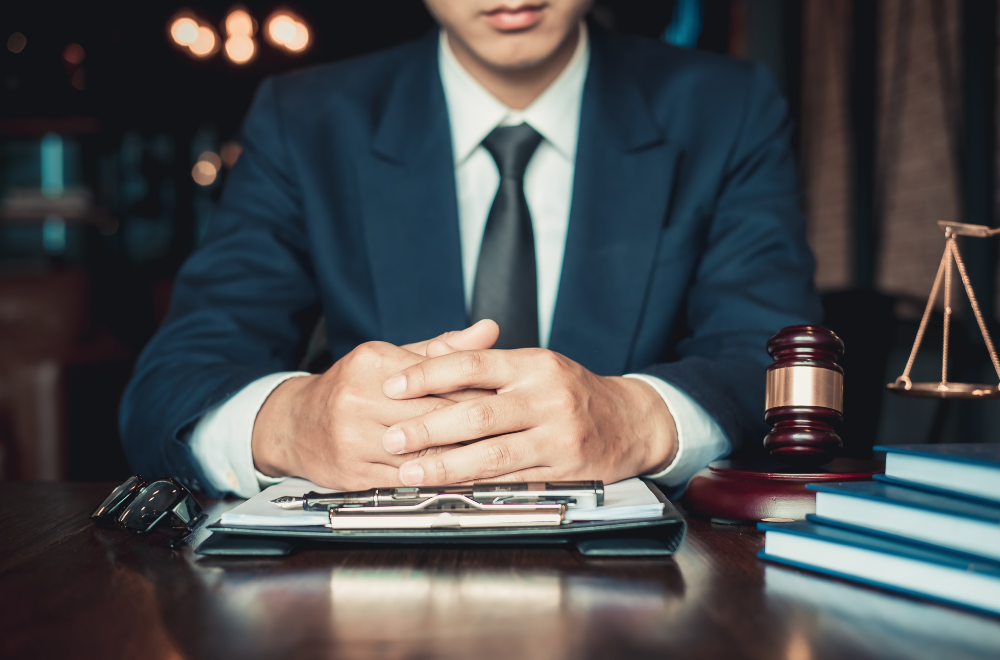 mercer county criminal defense lawyer sitting at desk with hands together