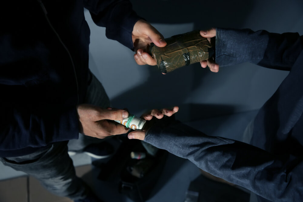 Drug trafficking exchange scene used to illustrate charges defended by an NJ drug trafficking lawyer.