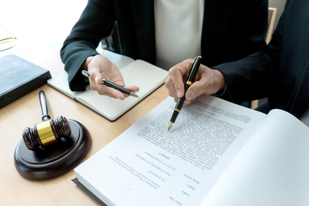 Attorney reviewing legal documents for a weapons forfeiture case in Monmouth County
